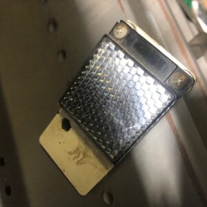 Old, worn smartphone with a cracked screen lying on a surface.