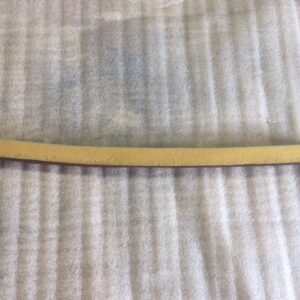 A wooden stick resting on a textured fabric surface.
