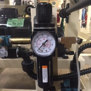 Pressure gauge attached to industrial piping system.