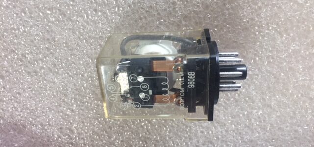 A small electronic component with a clear dome and metal pins.