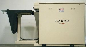 Close-up of an E-Z Fold LA-4000 paper folding machine.
