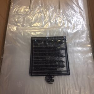 Small black vent or grate on a plastic-covered surface.