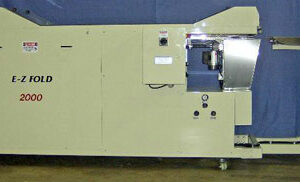 Industrial machine with control panel and conveyor belt system.