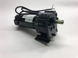 Black electric motor with attached cable and mounting bracket.