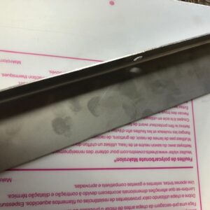 Close-up of a knife blade with fingerprints on it.