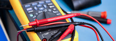 Multimeter probes resting on a digital multimeter.