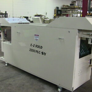 Industrial folding machine in a workshop setting.